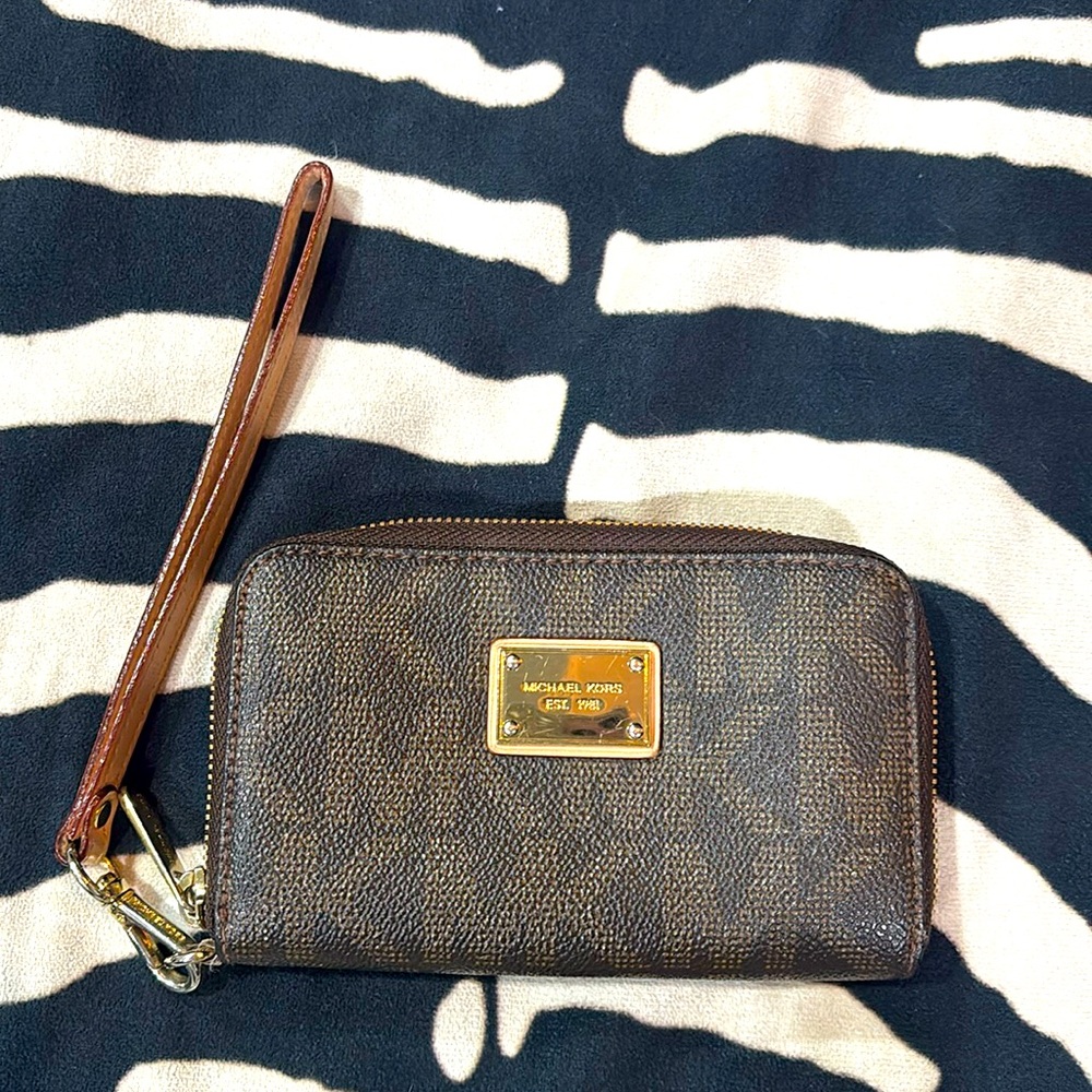 Michael Kors wristlet with gold toned harware and gold on inside